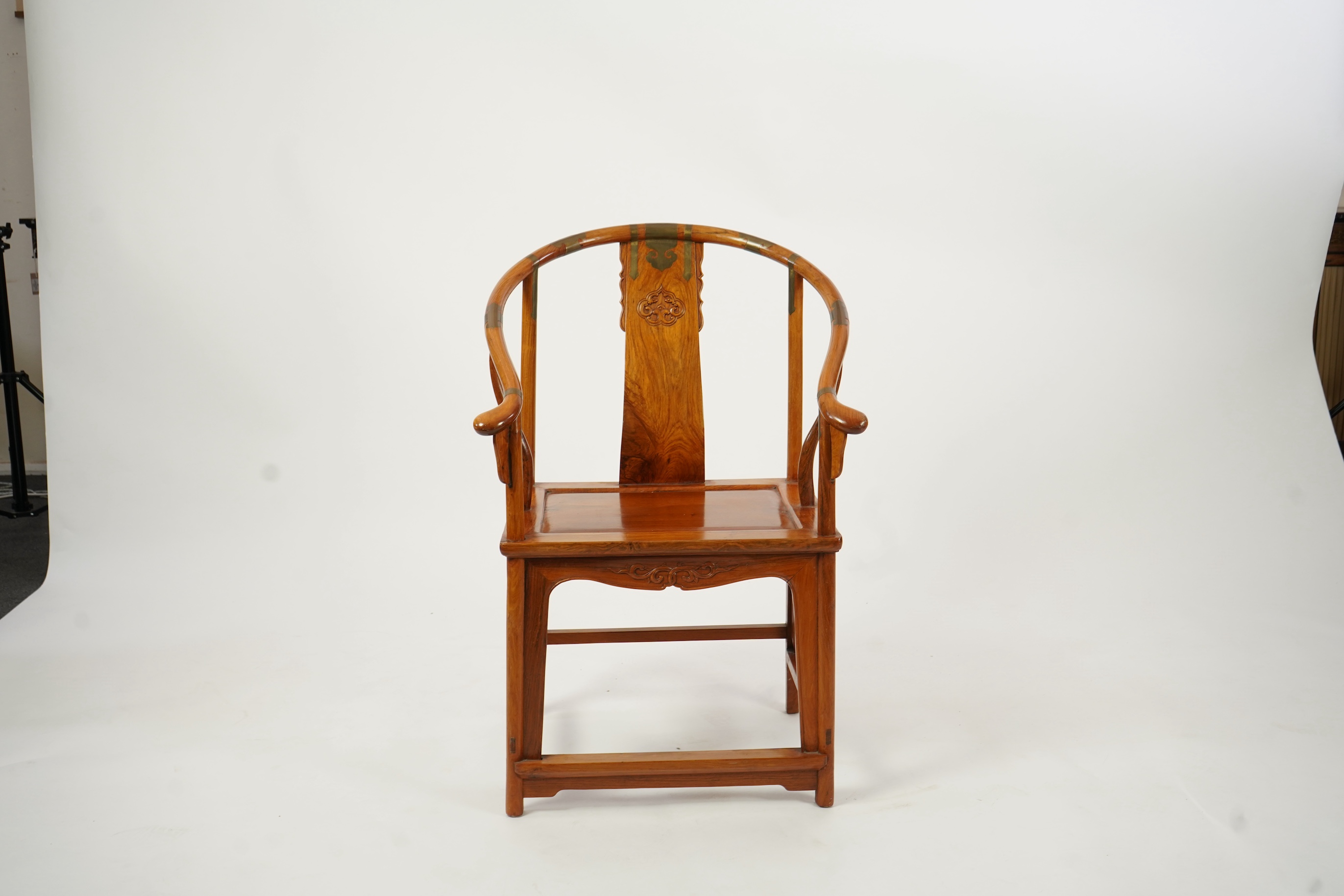A Chinese huanghuali and brass mounted horseshoe-back armchair, quanyi, late 19th century
